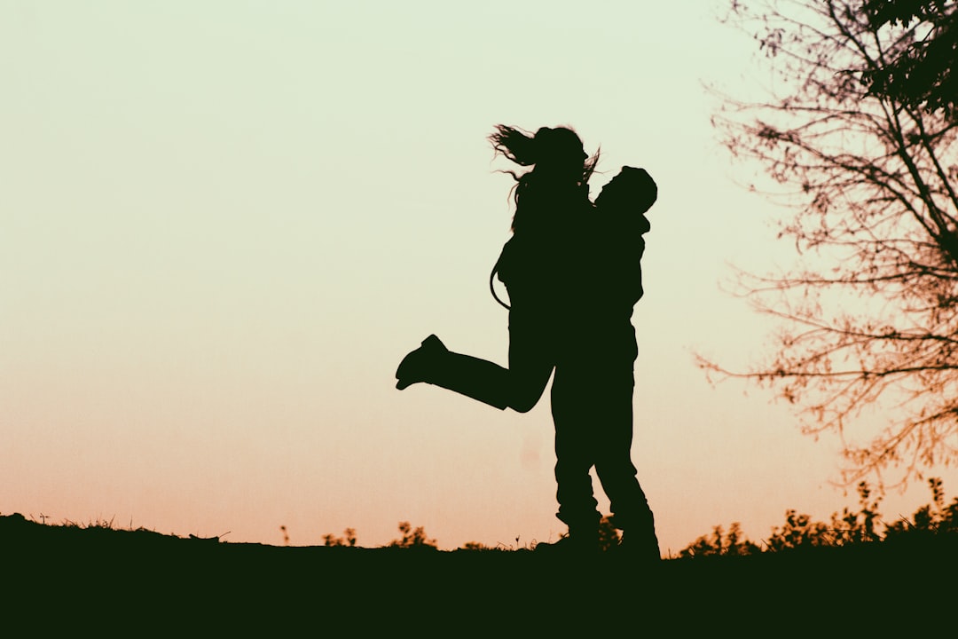 a-silhouette-of-a-man-and-a-woman-holding-each-other-ZRMHeRV_xE8