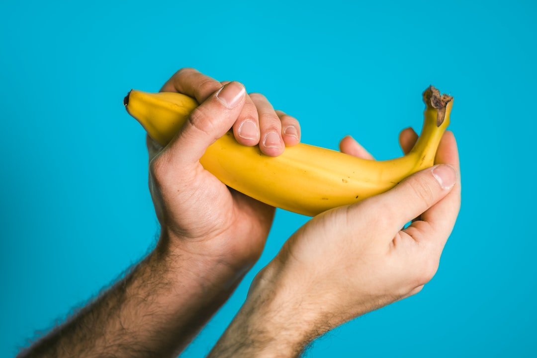 person-holding-banana-sJAI70yXlRQ