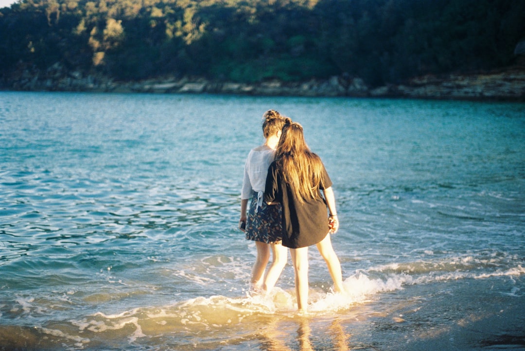 two-women-standing-on-seashore-ch5QGWmDBFA