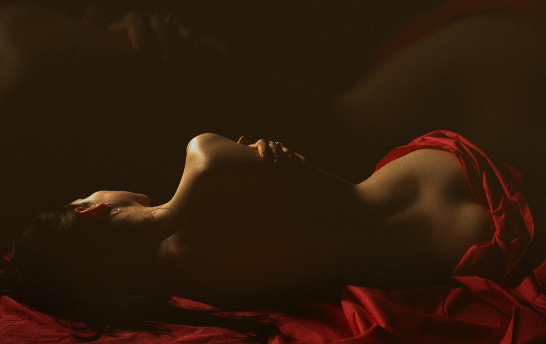 a-woman-in-a-red-dress-laying-on-a-bed-6GmVt60qwlY