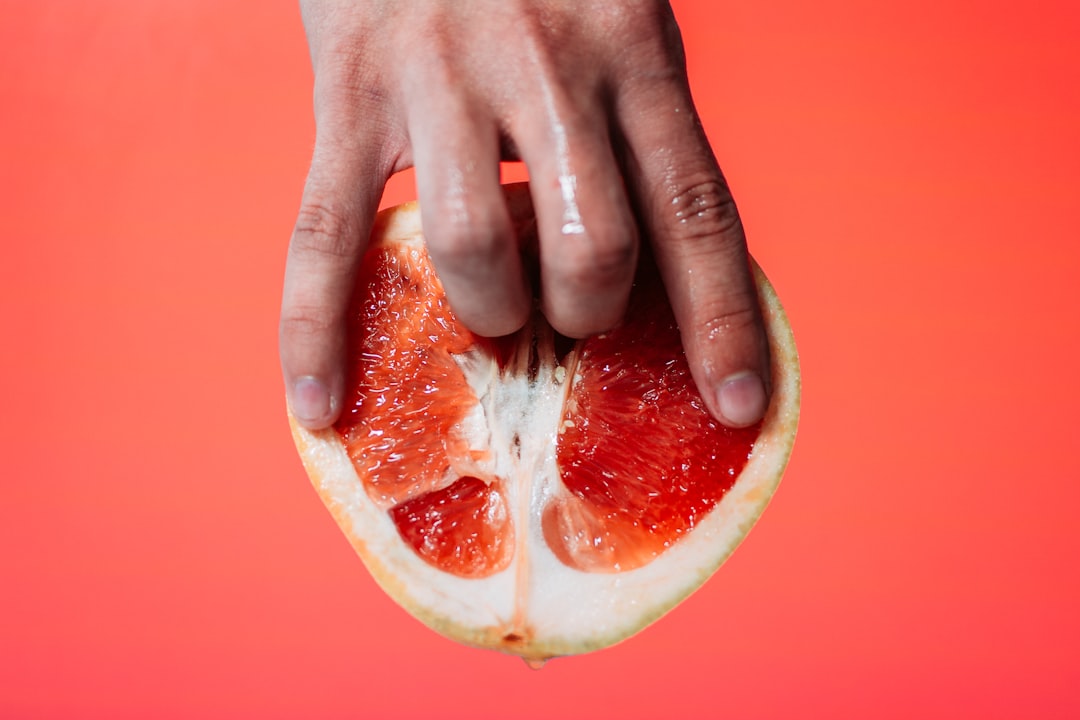person-holding-red-pomelo-fruit-mYt2lGON2cc