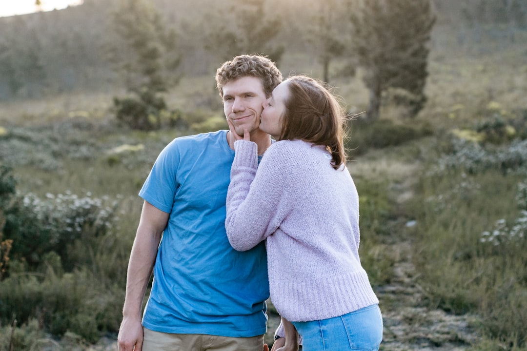 man-in-blue-crew-neck-t-shirt-hugging-woman-in-white-long-sleeve-shirt-1-_0dE1l2aQ