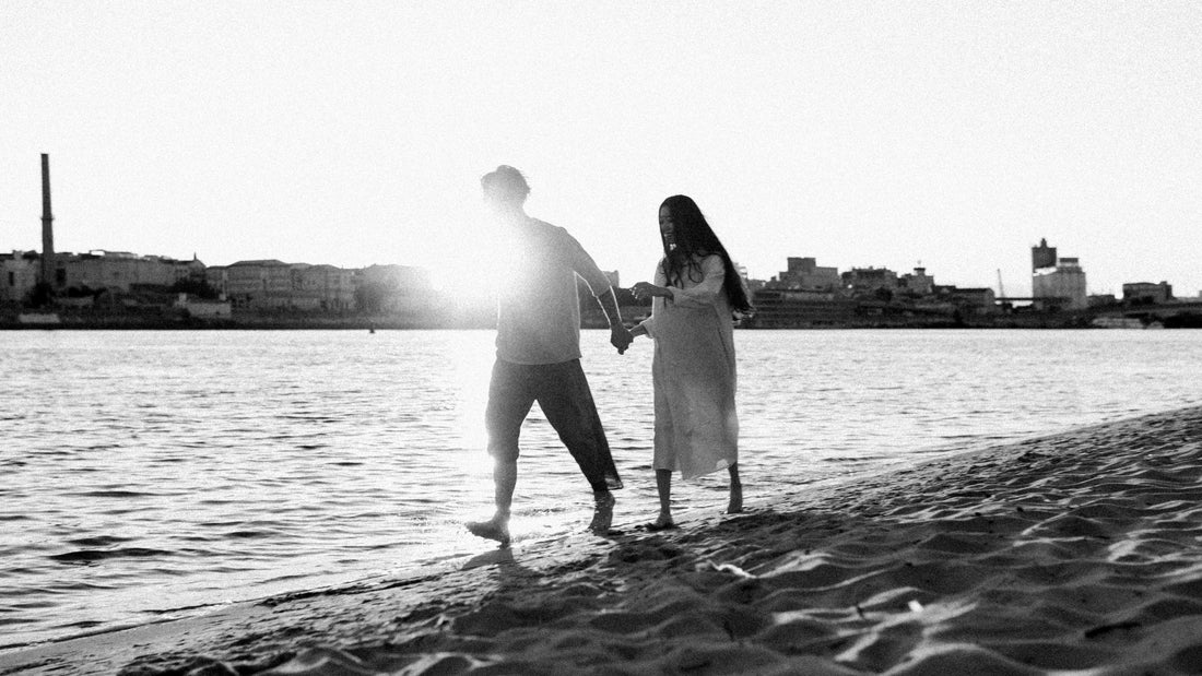 man and woman kissing on beach