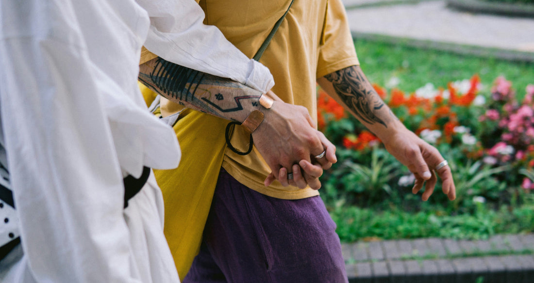 person in white long sleeve shirt holding brown and black fish