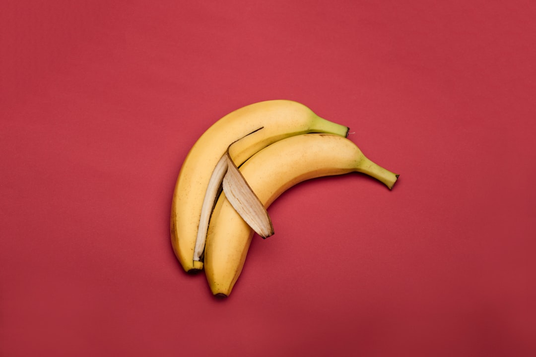 yellow-banana-fruit-on-red-textile-WOlAHR7Ko0A