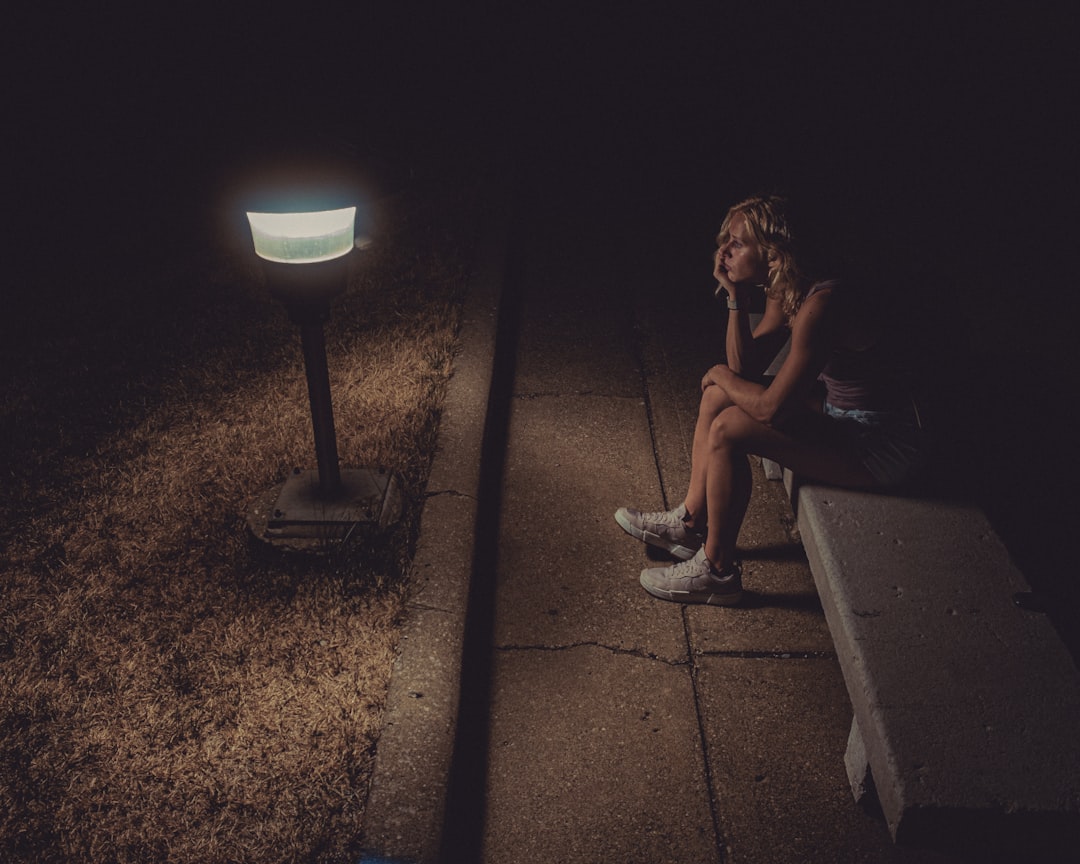woman-in-black-tank-top-sitting-on-concrete-floor-isVYj70Ar-E
