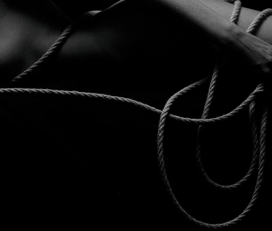 a-black-and-white-photo-of-a-woman-tied-up-rVskKY8RE4w