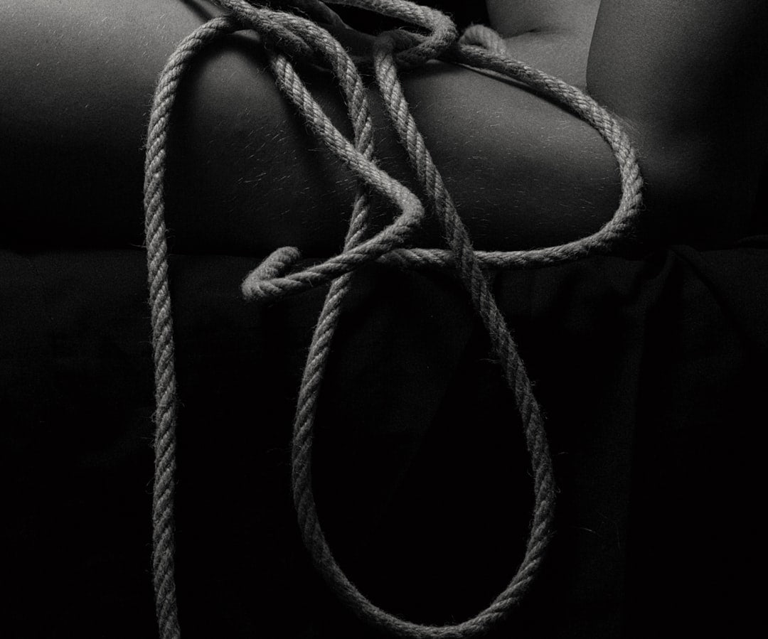 a-black-and-white-photo-of-a-person-holding-a-rope-wc0cQlDdfxQ