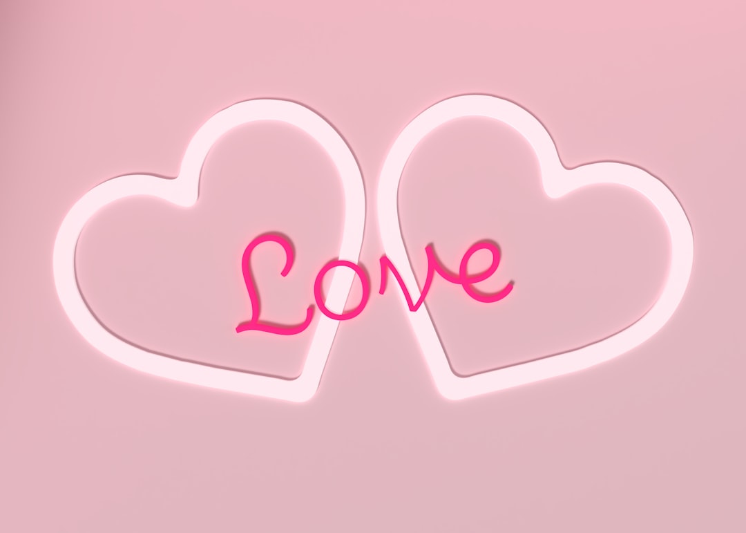 two-hearts-shaped-like-the-word-love-on-a-pink-background-p2A6n4QK36k