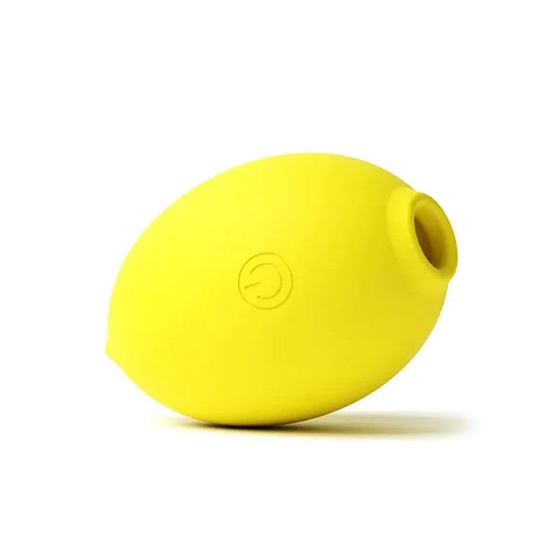 A bright yellow silicone lemon-shaped device with a small cylindrical opening on one end and an embossed circular logo on the front, shown on a plain white background.